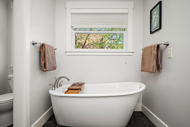1013 Planters Path, Bayport, MN 55003 - full bathroom featuring baseboards, tile patterned floors, toilet, and a freestanding bath