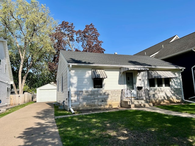 bungalow-style home featuring a garage, an outdoor structure, a shingled roof, stone siding, and driveway