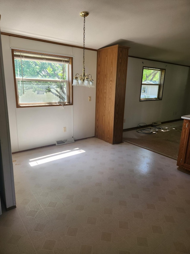 102 Jaybee Ln, Mankato, MN 56001 - unfurnished dining area featuring a chandelier and baseboards