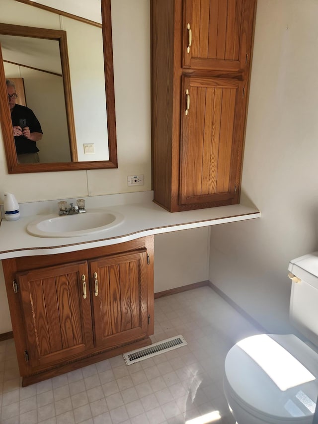 102 Jaybee Ln, Mankato, MN 56001 - bathroom with toilet, vanity, and tile patterned floors