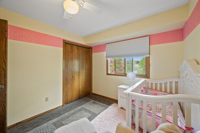 carpeted bedroom featuring a closet, baseboards, and a ceiling fan