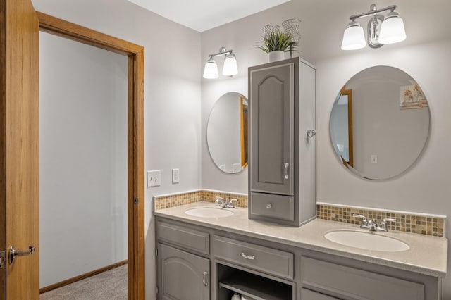 bathroom featuring double vanity and decorative backsplash