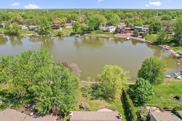 drone / aerial view of a large body of water and a heavily wooded area