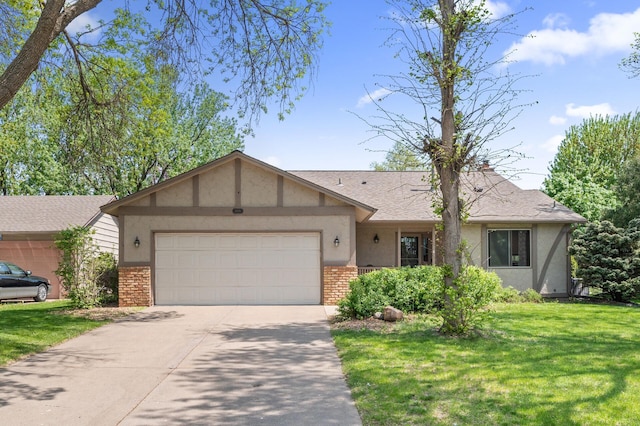 ranch-style home featuring brick siding, an attached garage, concrete driveway, stucco siding, and a front yard