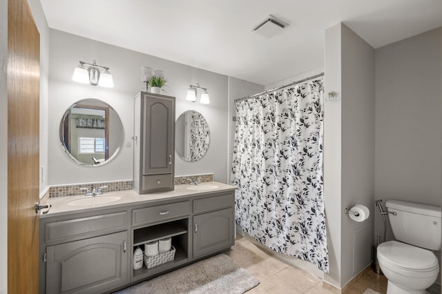 full bath featuring toilet, double vanity, tile patterned flooring, and a shower with shower curtain