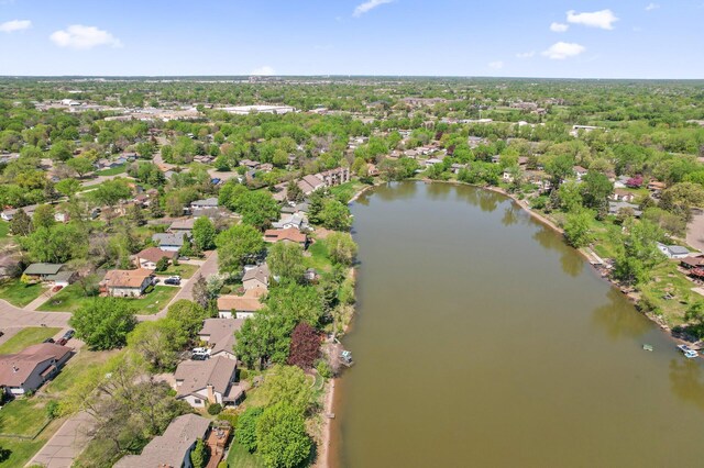 aerial view of property's location with a large body of water and nearby suburban area