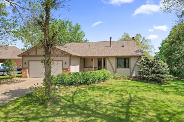 view of front of home featuring brick siding, stucco siding, an attached garage, and a front yard