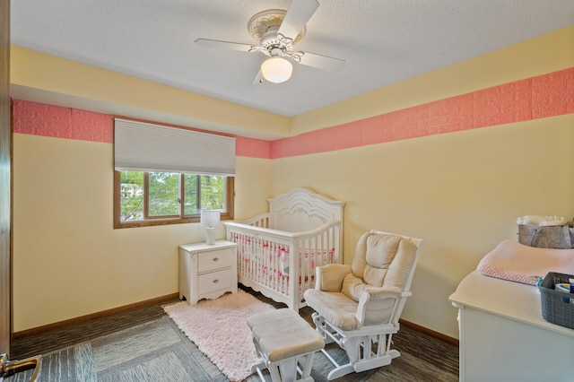 bedroom featuring ceiling fan, baseboards, and a textured ceiling