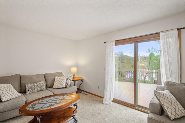 carpeted living room featuring baseboards