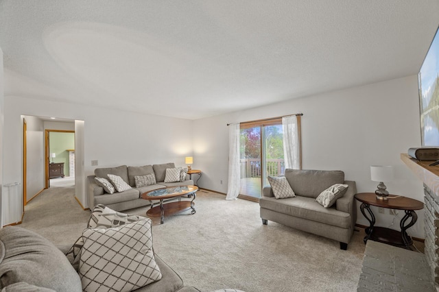 living area featuring light colored carpet, a textured ceiling, and baseboards