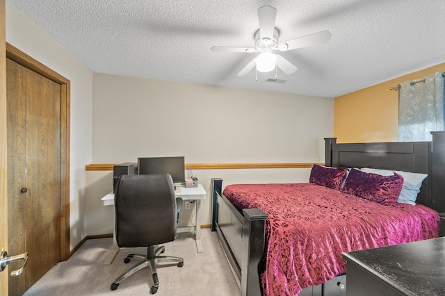 bedroom with light carpet, a textured ceiling, baseboards, ceiling fan, and an office area