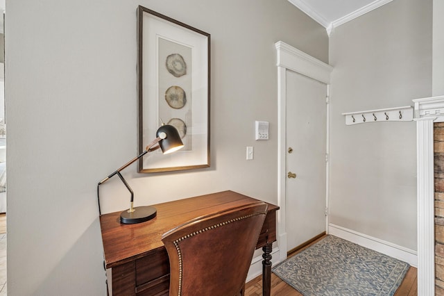 doorway to outside featuring crown molding, wood finished floors, and baseboards
