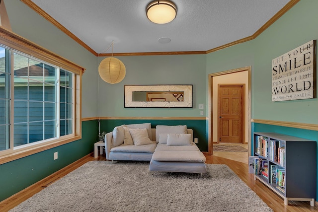 1502 9th St N, Sartell, MN 56377 - living area with wood finished floors, crown molding, and a textured ceiling