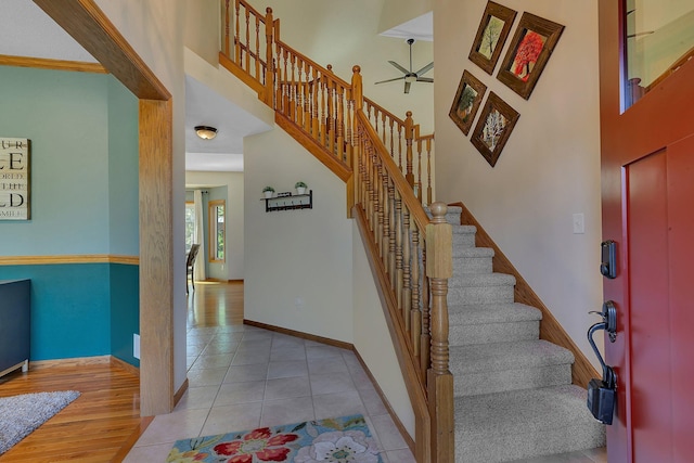 1502 9th St N, Sartell, MN 56377 - entrance foyer featuring a ceiling fan, a towering ceiling, baseboards, stairway, and tile patterned flooring