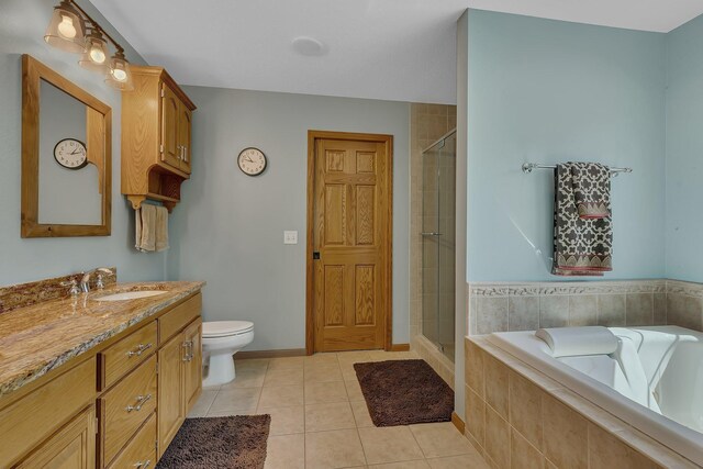 1502 9th St N, Sartell, MN 56377 - full bath featuring vanity, a shower stall, a garden tub, tile patterned flooring, and toilet