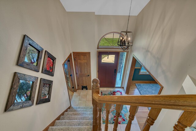 1502 9th St N, Sartell, MN 56377 - tiled foyer entrance featuring a high ceiling, a chandelier, stairs, and baseboards