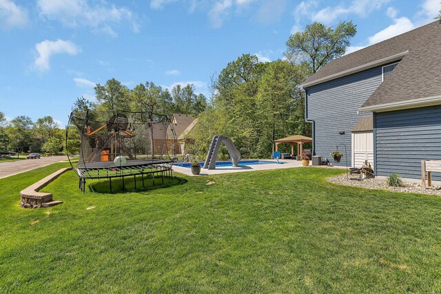 1502 9th St N, Sartell, MN 56377 - view of green lawn featuring a gazebo, a trampoline, and cooling unit