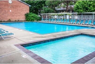 community pool with fence and a patio area