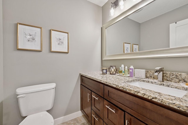 215 Barry Ave S Unit 306, Wayzata, MN 55391 - bathroom featuring toilet, baseboards, and vanity
