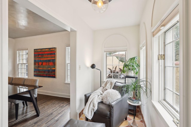 living area with baseboards and wood finished floors