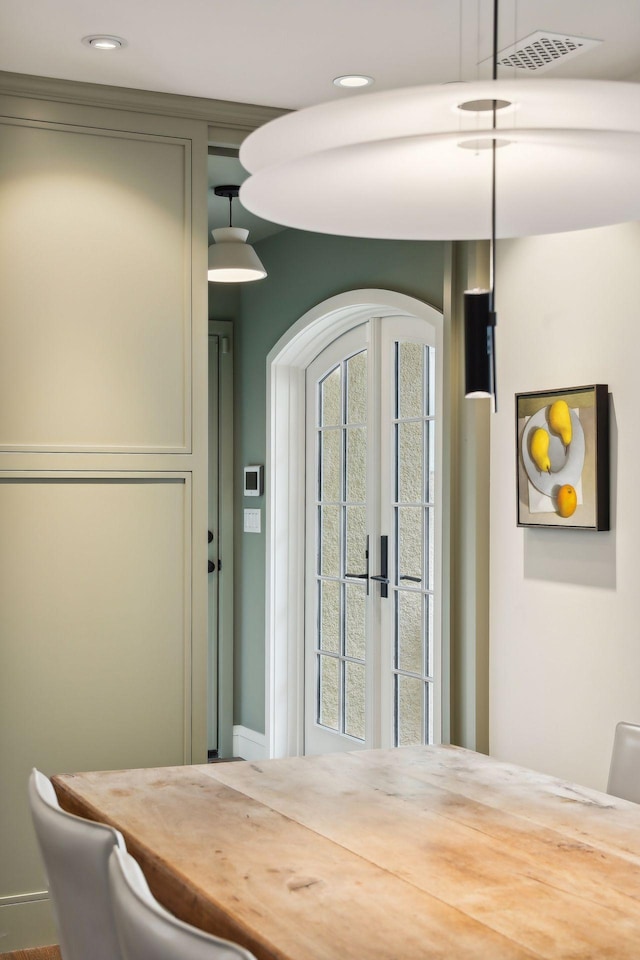 dining room with arched walkways and recessed lighting