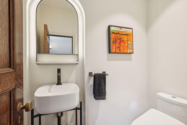 half bath with toilet and a sink