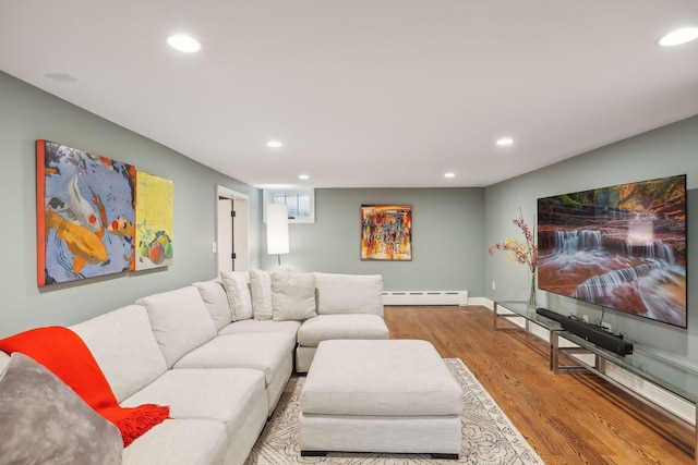 living area with baseboard heating, recessed lighting, and wood finished floors