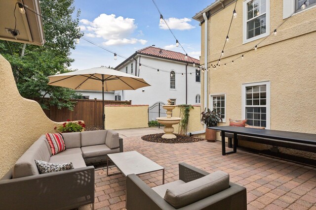 view of patio with outdoor lounge area and fence