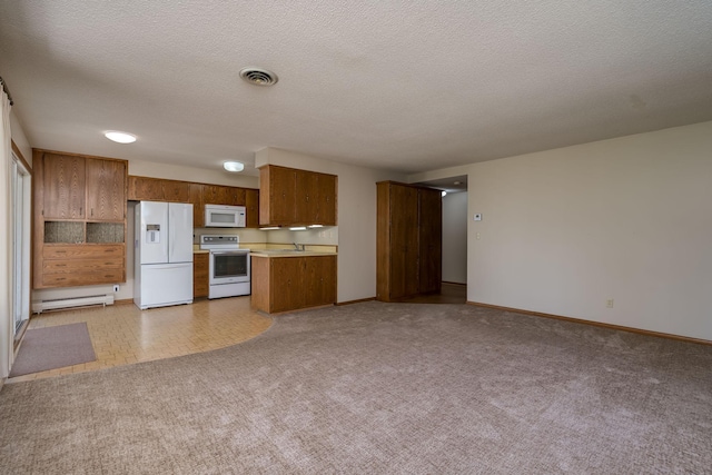529 Spring St Unit 4, Kenyon, MN 55946 - kitchen featuring white appliances, open floor plan, brown cabinetry, light countertops, and a sink