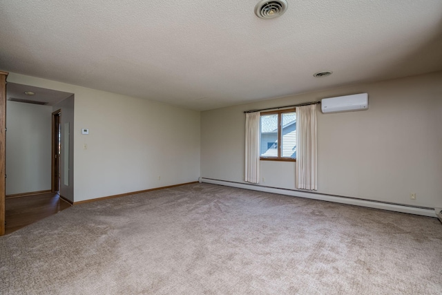 529 Spring St Unit 4, Kenyon, MN 55946 - carpeted empty room with a wall mounted AC, a baseboard radiator, baseboards, and a textured ceiling