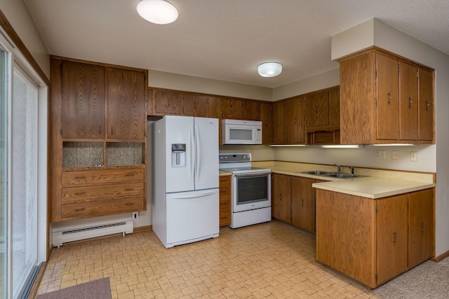 529 Spring St Unit 4, Kenyon, MN 55946 - kitchen featuring white appliances, a baseboard heating unit, a sink, light countertops, and brown cabinets