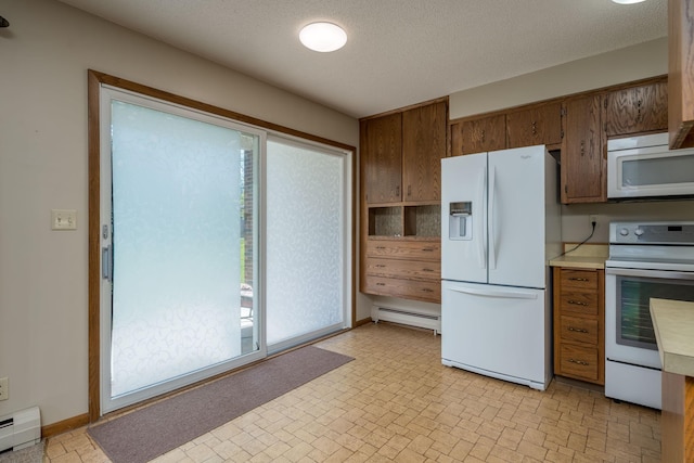 529 Spring St Unit 4, Kenyon, MN 55946 - kitchen featuring white appliances, a baseboard radiator, and plenty of natural light