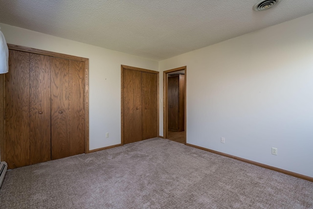 529 Spring St Unit 4, Kenyon, MN 55946 - unfurnished bedroom featuring multiple closets, carpet flooring, and baseboards