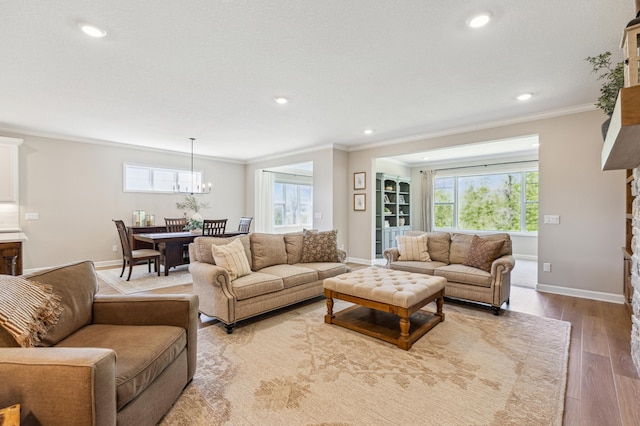 8014 Walnut Ln, Corcoran, MN 55340 - living area featuring ornamental molding, recessed lighting, a chandelier, plenty of natural light, and wood finished floors