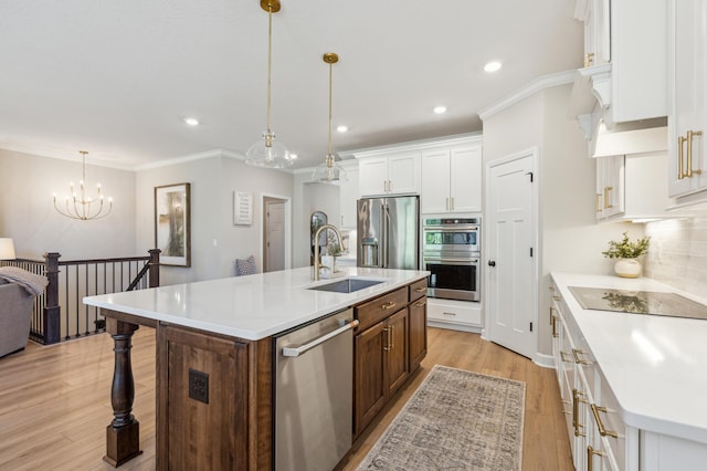 8014 Walnut Ln, Corcoran, MN 55340 - kitchen featuring stainless steel appliances, white cabinetry, light countertops, a kitchen island with sink, and a kitchen breakfast bar