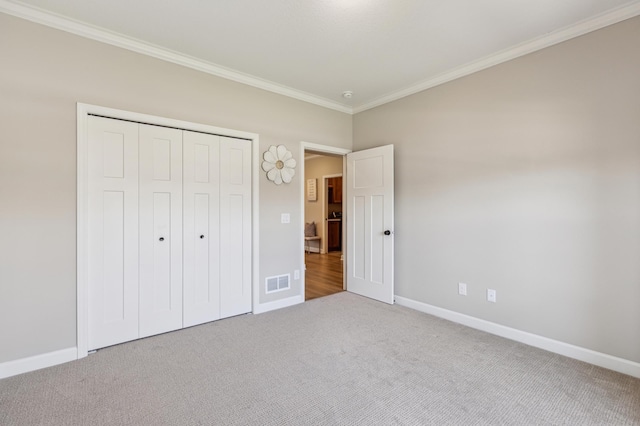 8014 Walnut Ln, Corcoran, MN 55340 - unfurnished bedroom featuring ornamental molding, carpet flooring, and a closet