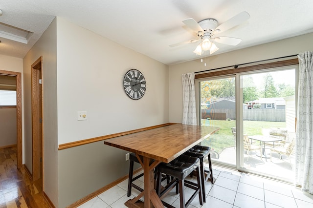 dining room with ceiling fan and baseboards
