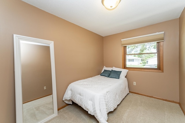 bedroom featuring baseboards and carpet floors