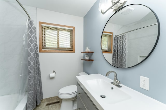 full bathroom featuring healthy amount of natural light, toilet, vanity, and shower / tub combo
