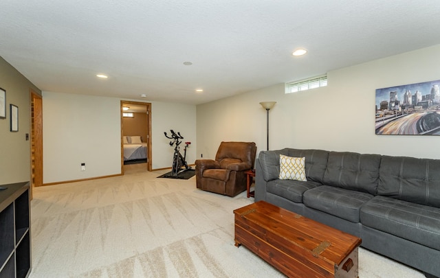 carpeted living area featuring recessed lighting and baseboards