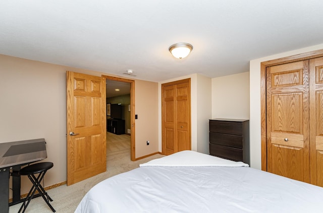 bedroom featuring light colored carpet and baseboards