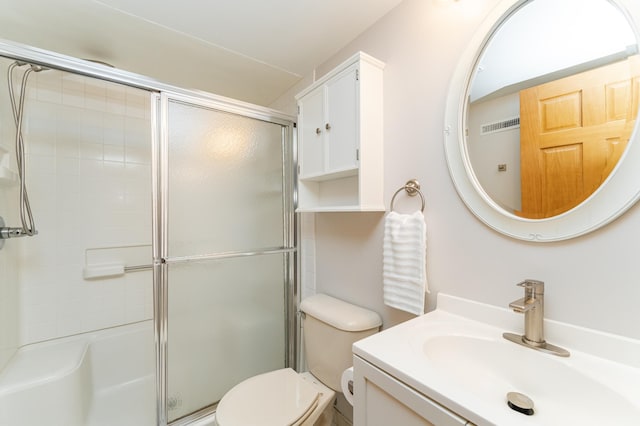 bathroom featuring an enclosed shower, toilet, and vanity
