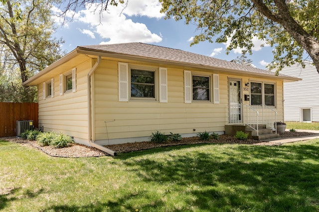 ranch-style house with roof with shingles and central AC