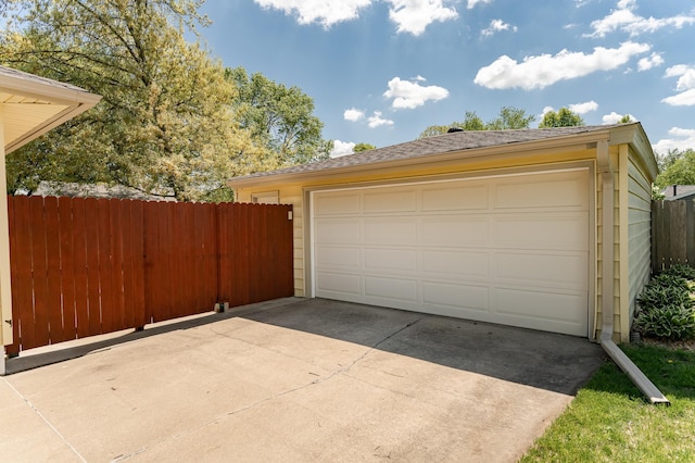 detached garage featuring fence