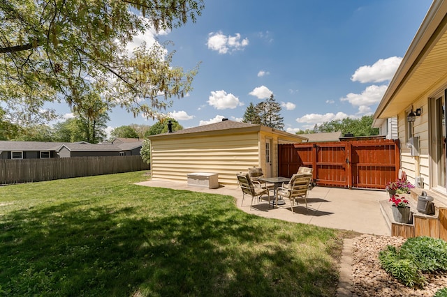 view of yard featuring a patio area and a gate