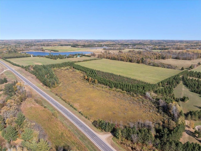 aerial overview of property's location with a nearby body of water and rural landscape