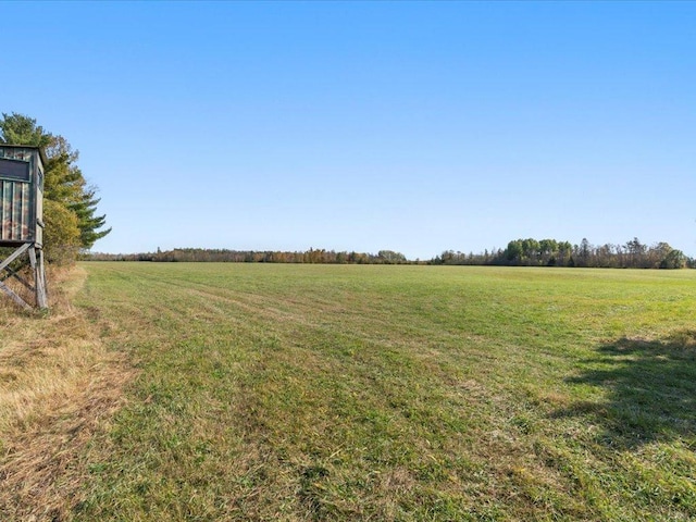 view of green lawn with a view of countryside