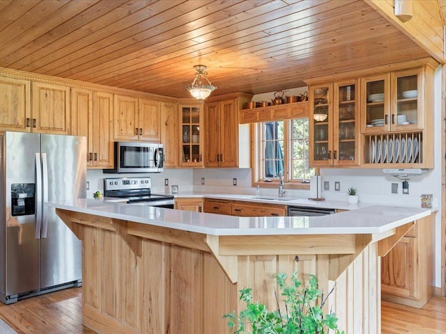 kitchen featuring appliances with stainless steel finishes, a sink, wooden ceiling, light countertops, and light wood-style floors