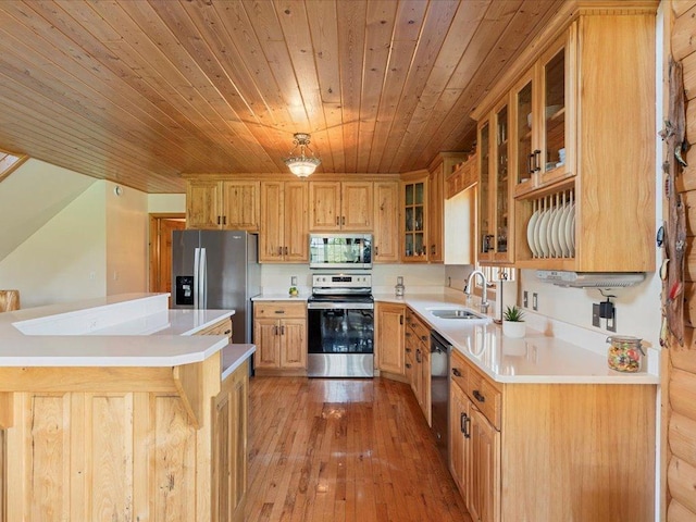 kitchen featuring stainless steel appliances, a sink, wooden ceiling, light wood finished floors, and light countertops