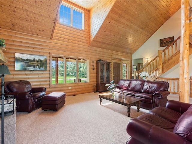 carpeted living room with high vaulted ceiling, log walls, plenty of natural light, stairway, and wooden ceiling